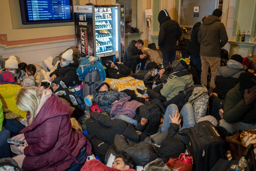 Groups of people with their belongings sleeping on chairs and on the floor of  Przemyśl Główny Station, six days after the start of Russia's attacks on Ukraine