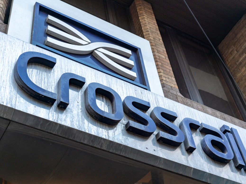 Close-up of the Crossrail train sign and logo seen above the main entrance in London.
