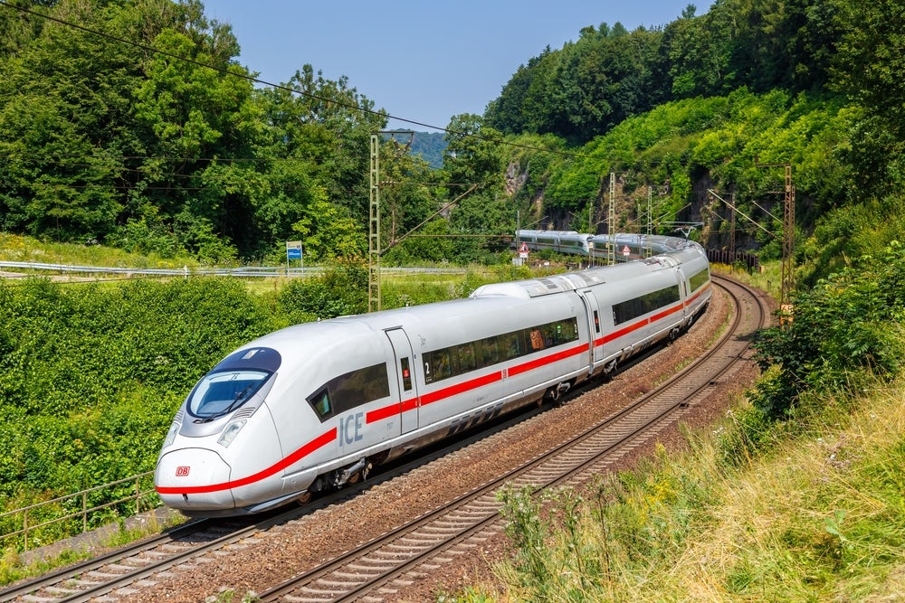 A photo of a DB ICE 3 turning around a bend on a high-speed railway