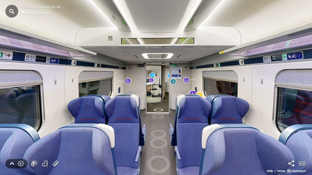 A screenshot of Lumo's virtual train carriage tour showing a picture of the rear of a carriage with blue information icons over different sections.