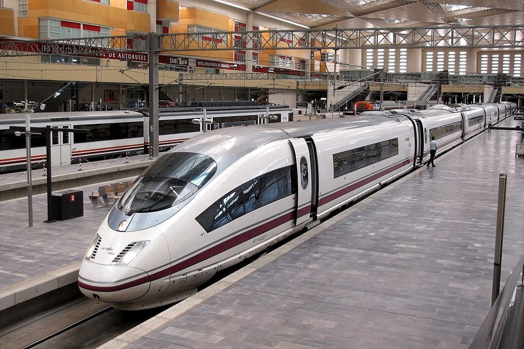A Siemens Velaro Renfe class 103 sat at a train station.