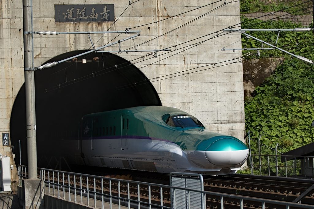 Photo of a Shinkansen high-speed train exiting the Seikan Tunnel, the longest railway tunnel in the Asia.
